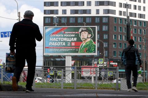 A billboard promoting contract army service with an image of a serviceman and the slogan reading "Serving Russia is a real job" sits in Saint Petersburg, Russia, on September 20.