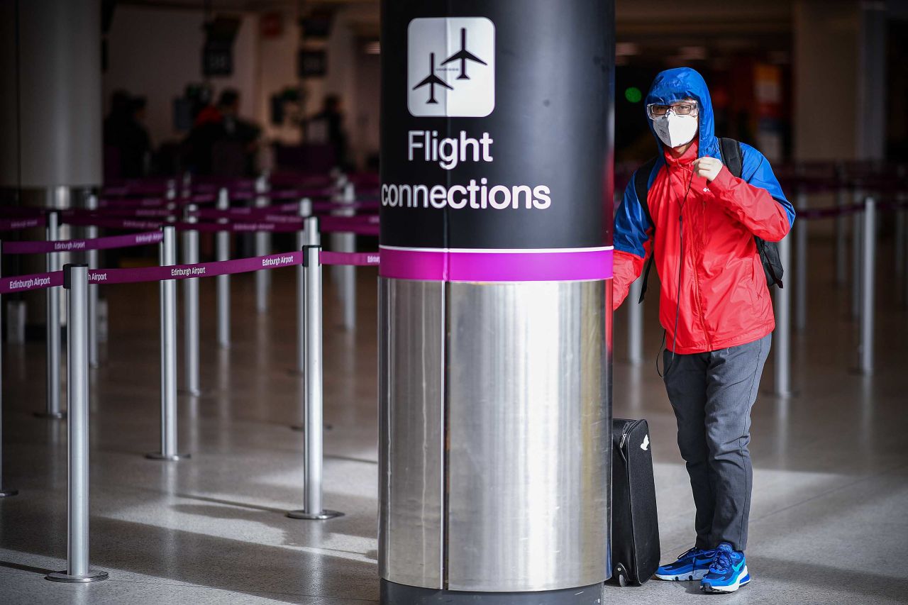 A traveler is pictured at Edinburgh Airport in Scotland on March 16.