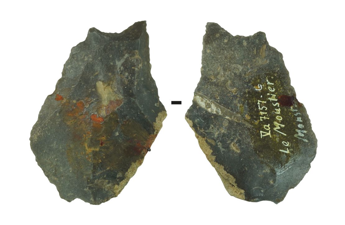 A stone artifact (front and back) with remains of a bitumen-ocher mixture comes from the upper rock shelter of a French archaeological site called Le Moustier.