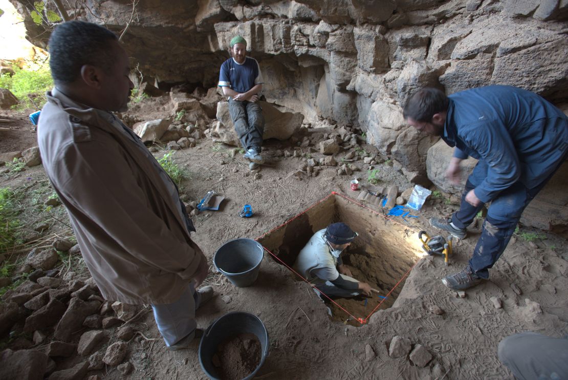 The research team is seen during an excavation at Umm Jirsan. The archaeologists uncovered human remains, animal bones, carved wood and stone tools at the site.