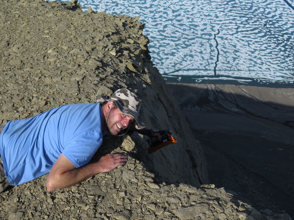 Study coauthor David Bond, a paleoenvironmental scientist at the University of Hull, looks for new sections of rock that reflect the end-Permian mass extinction on Ellesmere Island in the Canadian Arctic.