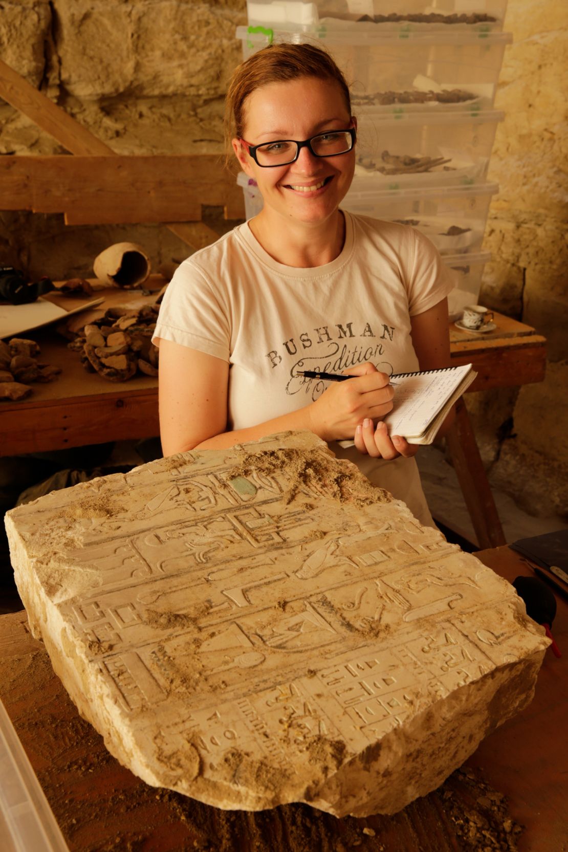 Egyptologist Veronika Dulíková appears on site at Abusir documenting a hieroglyphic inscription from the tomb of the official Idu.