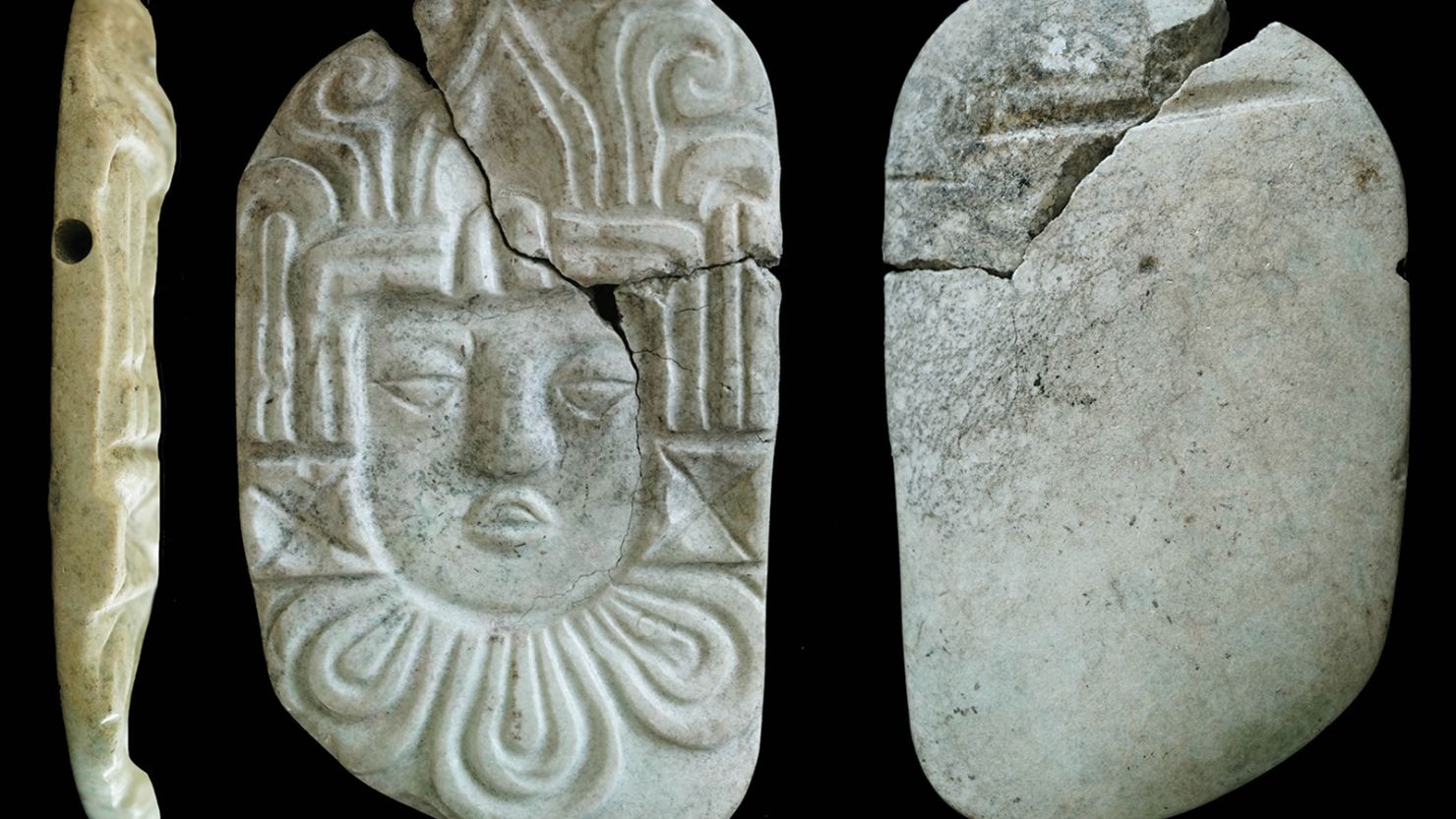 Burned grave goods found in a Maya pyramid with charred royal bones included a carved pendant plaque of a human head.