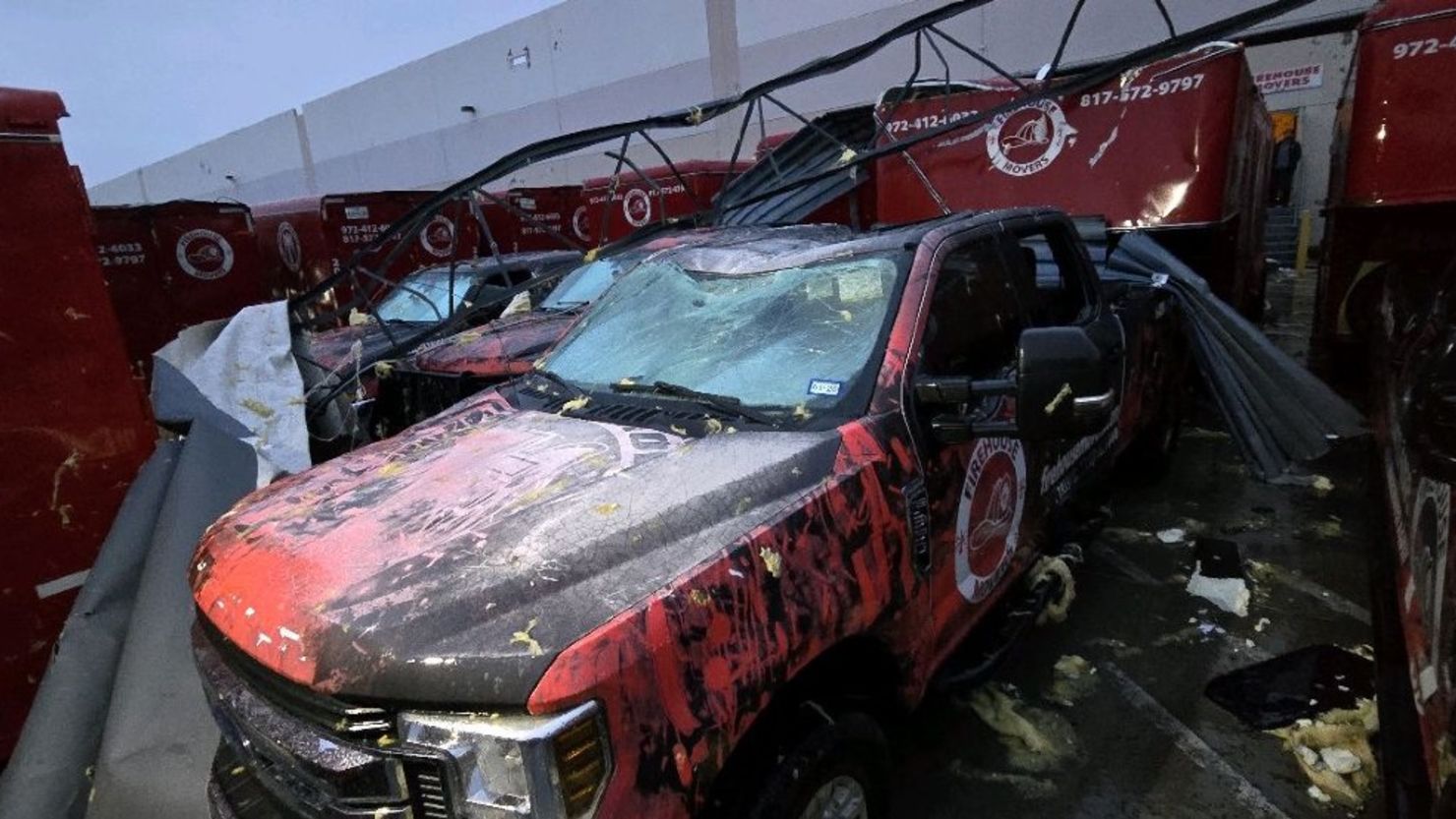 Debris piles on vehicles in Lewisville, Texas, on Tuesday after a storm with powerful winds swept through the area