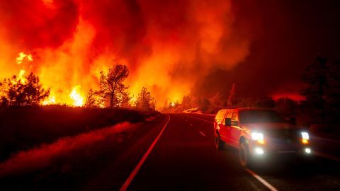 Smoke rises above the roadway as the Park Fire jumps Highway 36 near Paynes Creek in Tehama County, Califoria, on Friday, July 26, 2024.