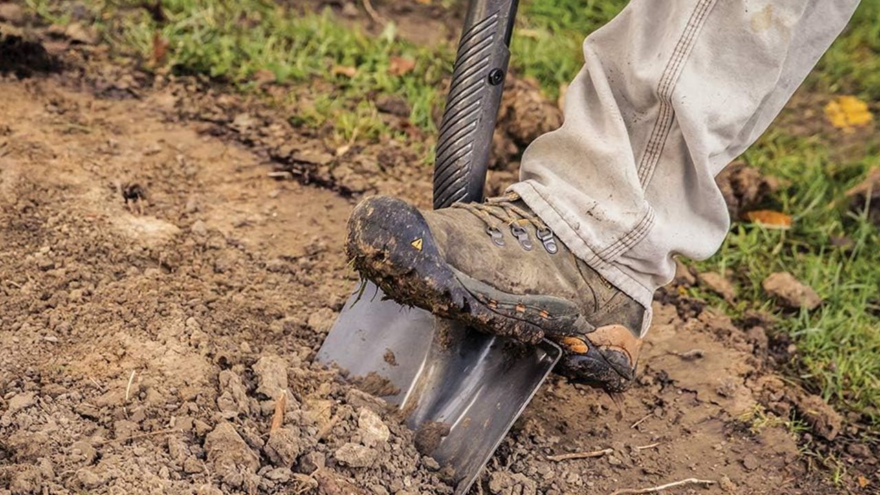 Person using Fiskars 60-Inch Pro Digging Shovel