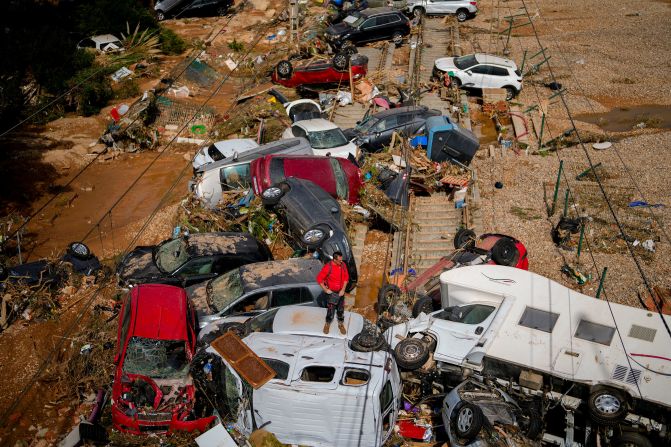 A man stands among damaged vehicles in Valencia on Thursday.