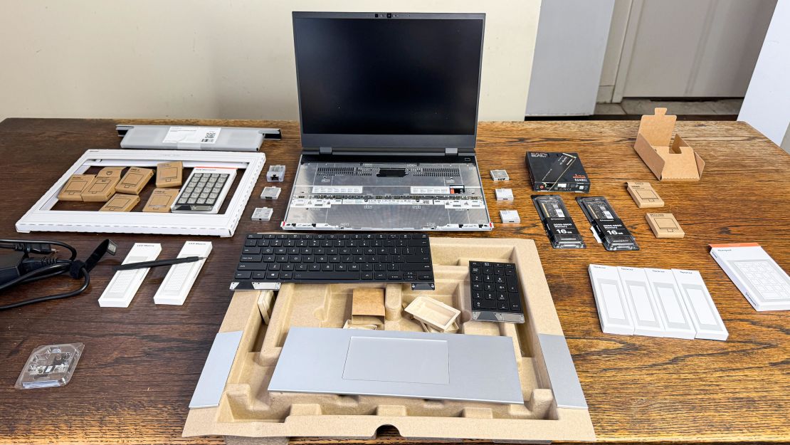 The Framework Laptop 16 turned off, surrounded by all of its parts including keyboard, spacer, touchpad and ports.