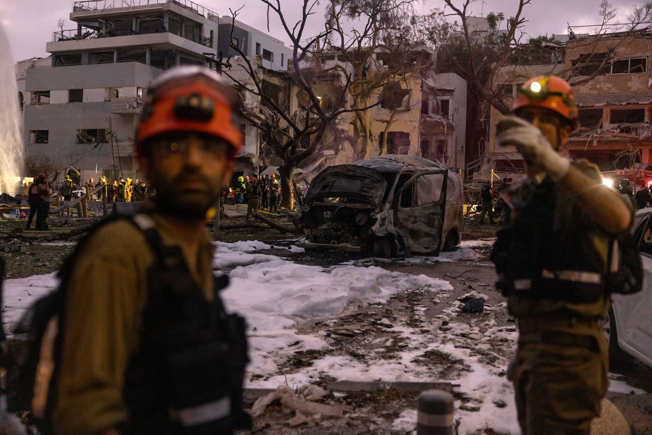 Fuerzas de rescate en un edificio que fue alcanzado por misiles balísticos en Tel Aviv, Israel, el lunes