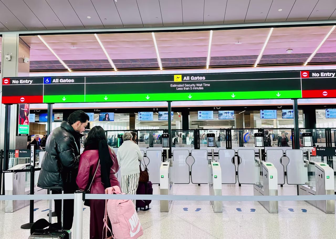 People stand at Newark Airport in Newark, New Jersey, on Tuesday.