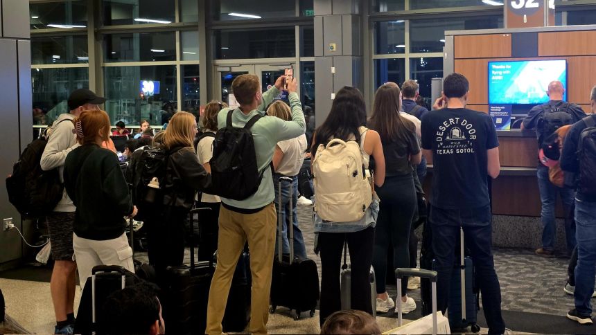 Passengers wait for news about delayed flights at Austin-Bergstrom International Airport.