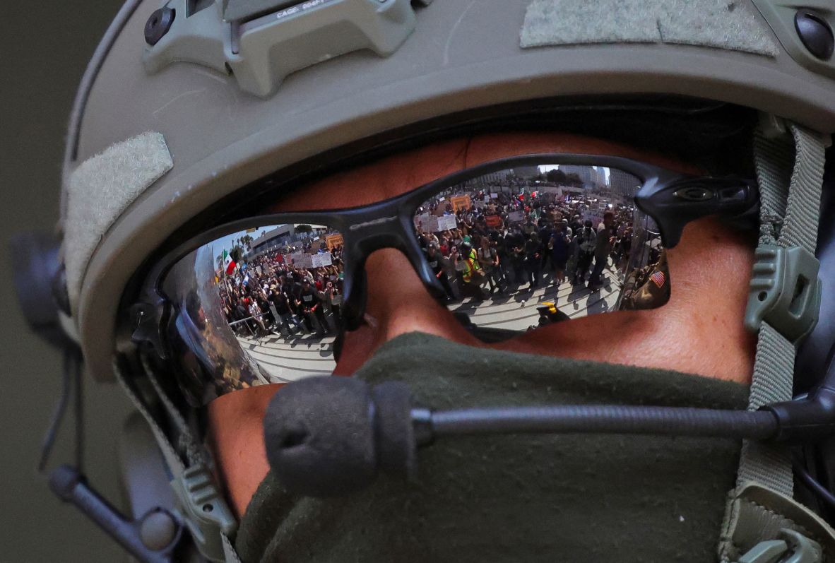 Protesters are reflected in the sunglasses of a law enforcement officer on Monday.
