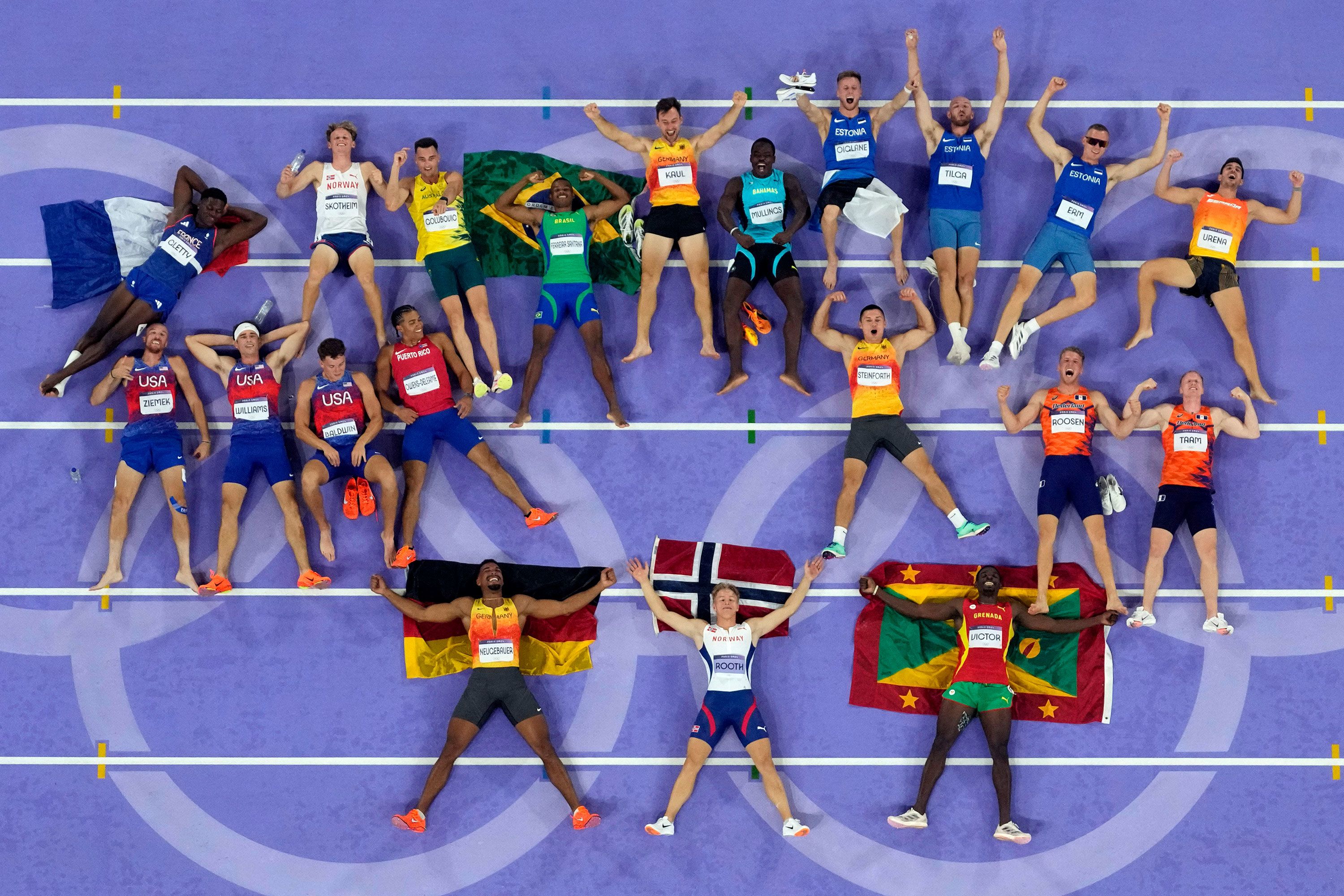 Decathletes lie on the track for a photo at the end of the last event on August 3. At bottom are silver medalist Leo Neugebauer of Germany, <a href="https://www.cnn.com/sport/live-news/paris-olympics-news-2024-08-03#h_9c00eb3c8d1e6ed8000070bcdc89745d">gold medalist Markus Rooth of Norway</a> and bronze medalist Lindon Victor of Grenada.