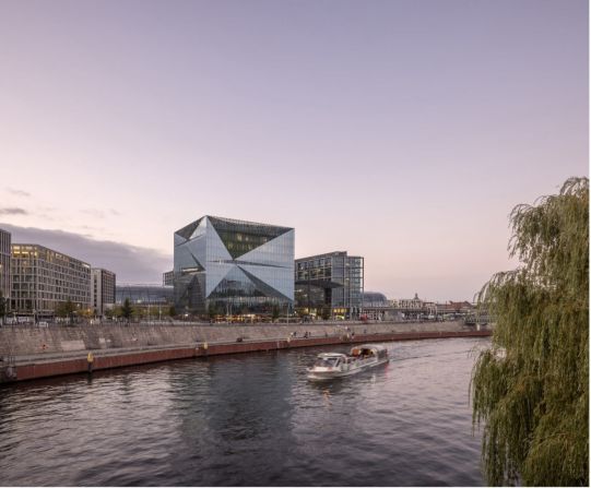 Cube Berlin, designed by 3XN as a futuristic office space, has a ventilated double-skin glass fa?ade that helps reduce the amount of energy required to operate the building. It is located next to a central railway station, making it easy for workers to use public transport.