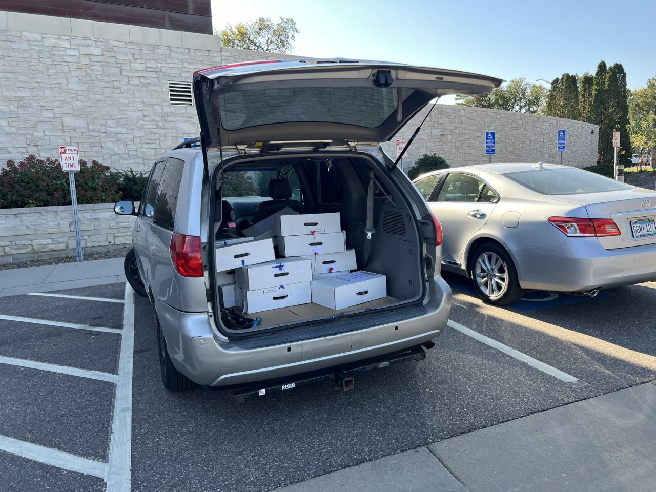 Boxes of ballots are seen in the back of a courier’s car outside Edina City Hall in Minnesota.