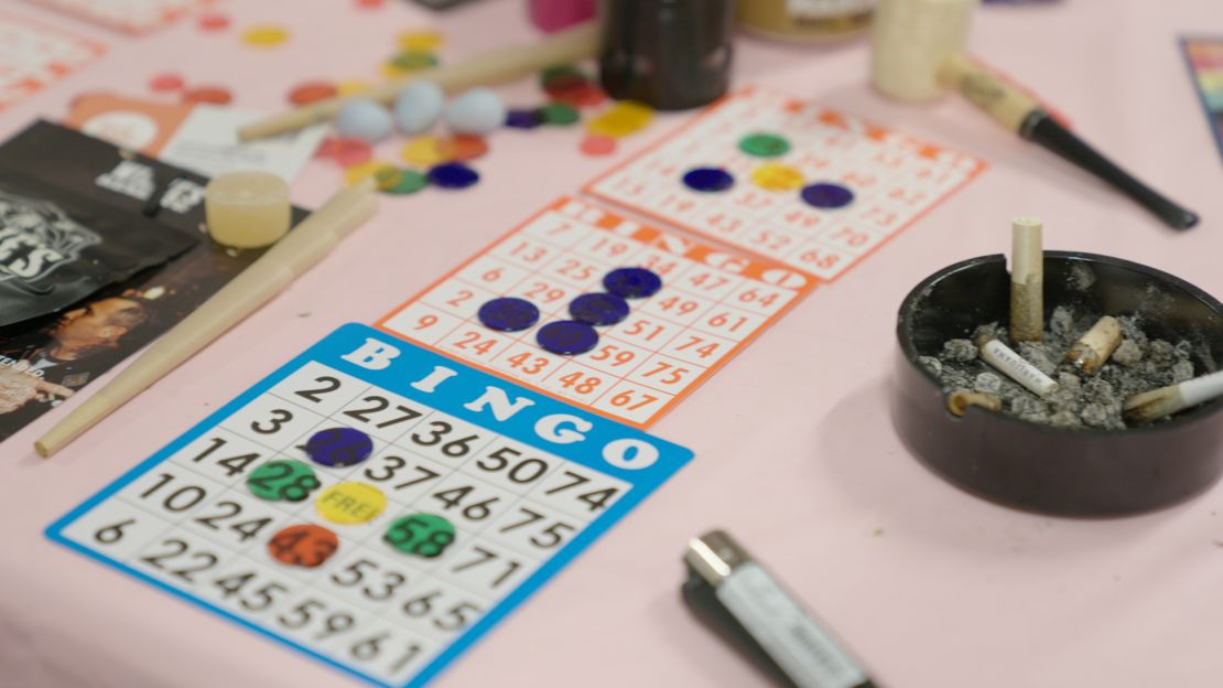 Bingo cards are seen alongside ashtrays with finished joints.
