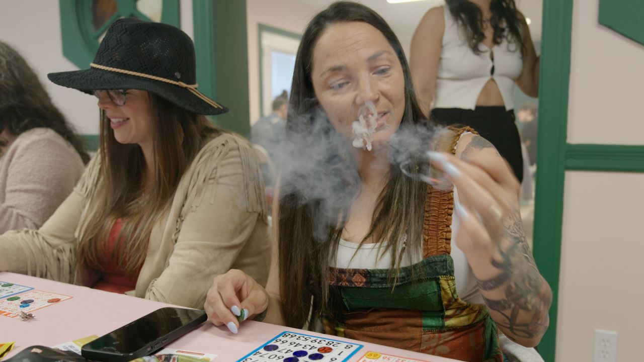 Jamie Cerda smokes weed while playing bingo at an STL Cannamoms event.