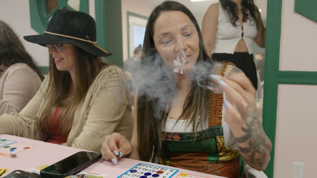 Jamie Cerda smokes a joint while playing bingo at the STL Cannamoms event.