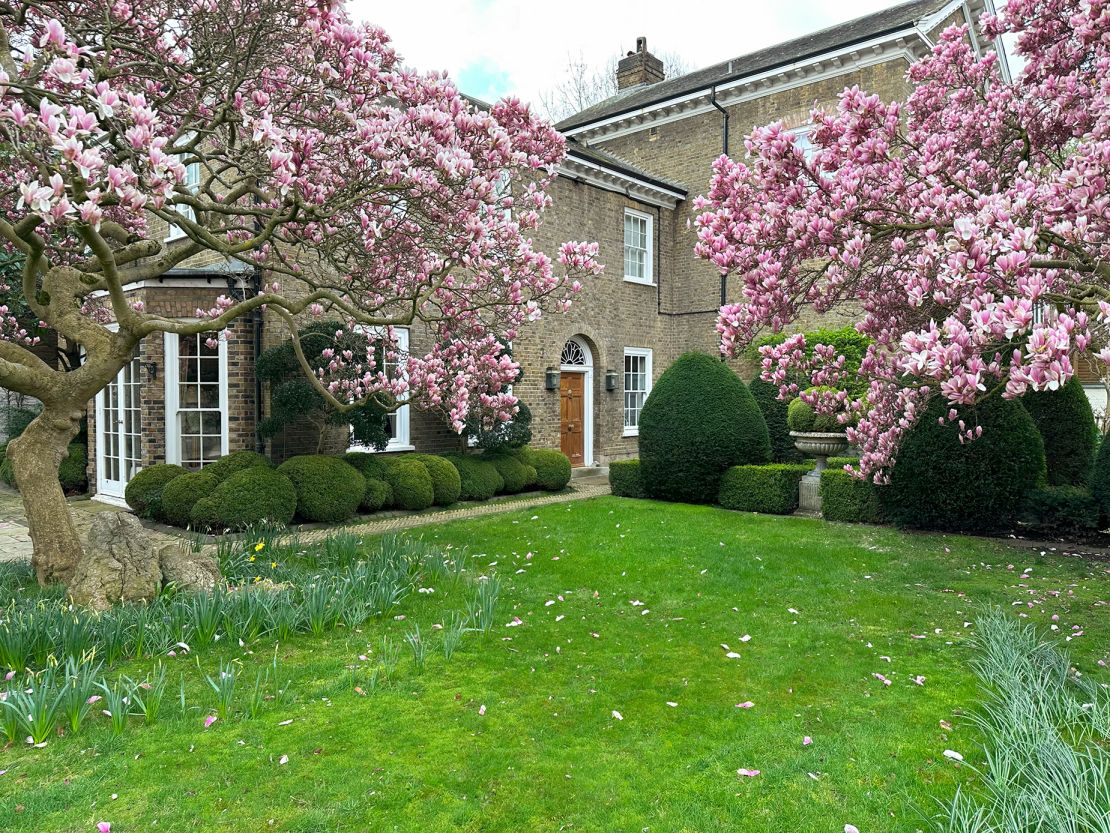 The property's garden, featuring a host of topiary and mature trees, including magnolia trees.