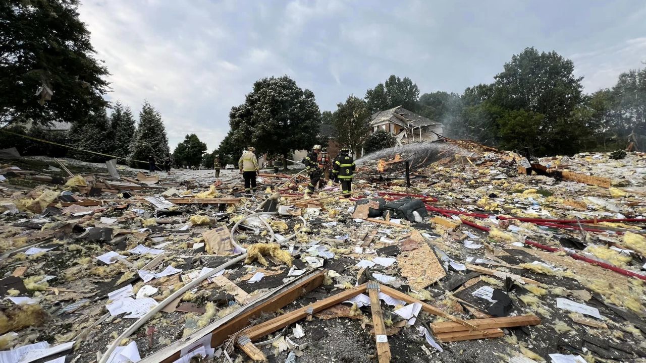 First responders walk through debris in the aftermath of a home explosion in Harford County, Maryland, on August 11, 2024.