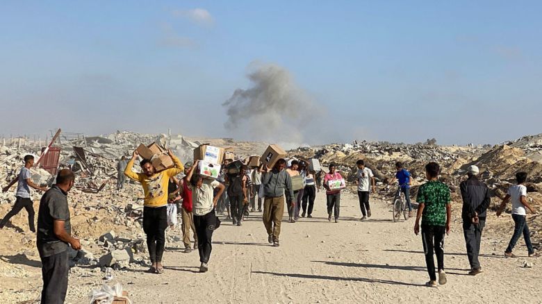 Palestinos desplazados reciben paquetes de alimentos de una fundación respaldada por Estados Unidos que se compromete a distribuir ayuda humanitaria en el oeste de Rafah, en el sur de Gaza, el 27 de mayo de 2025.