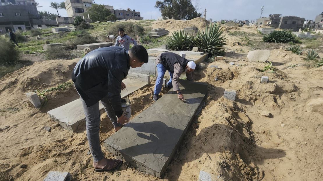 Graves are covered in cement, into which some etch epitaphs.