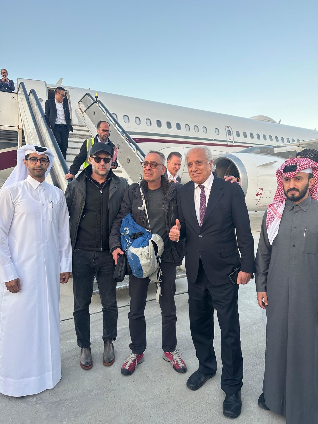 This photo shared with CNN by a Qatari diplomat shows George Glezmann, center, with Qatari diplomats, Adam Boehler, and Zalmay Khalilzad in Kabul, Afghanistan, before departing to Doha, Qatar. 