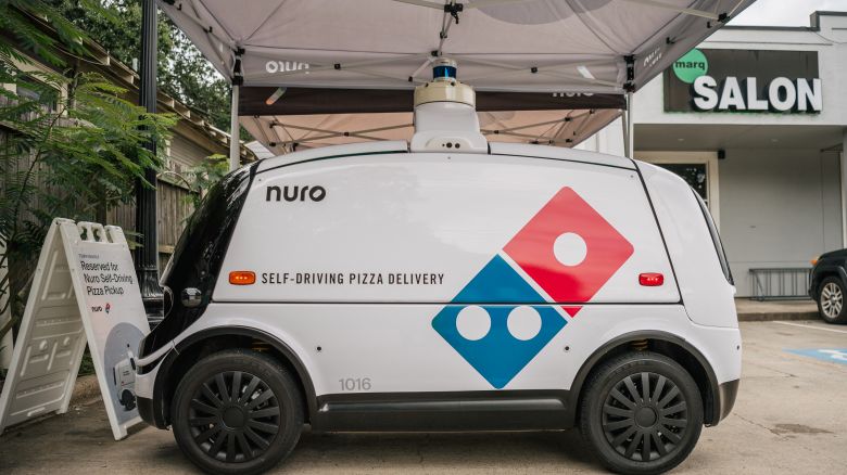 HOUSTON, TEXAS - JULY 22: A Domino's Pizza self-driving delivery vehicle is shown on July 22, 2021 in Houston, Texas. The company has said that select customers in Houston who make pre-paid delivery orders from its store in Woodland Heights, during certain dates and times, can have their pizza delivered to them by their self-driving Nuro R2 robot. Domino's pizza has reported that its U.S. same-store sales have increased by 3.5% in its latest quarter of production. CEO Ritch Allison has said that the company will raise wages for employees, in certain markets and positions, at corporate-owned restaurants. Allison also noted that a lack of staffing and equipment shortages have been major hurdles as the company continues to deal with problems tied to the pandemic.  (Photo by Brandon Bell/Getty Images)