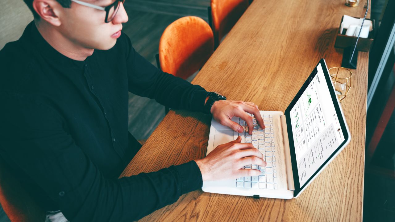 A person checking investments on a laptop.
