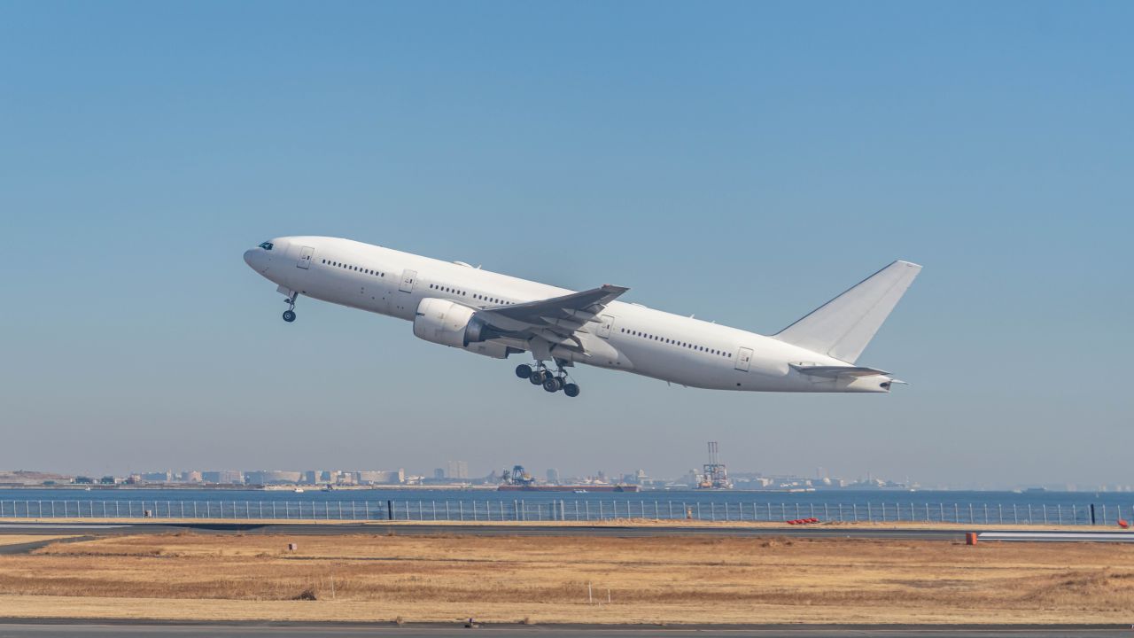 A white airplane taking off in Tokyo