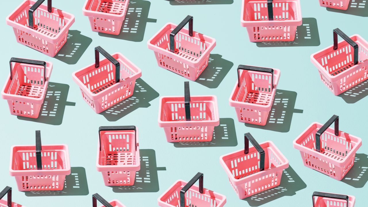 Pink grocery shopping baskets on a celeste background