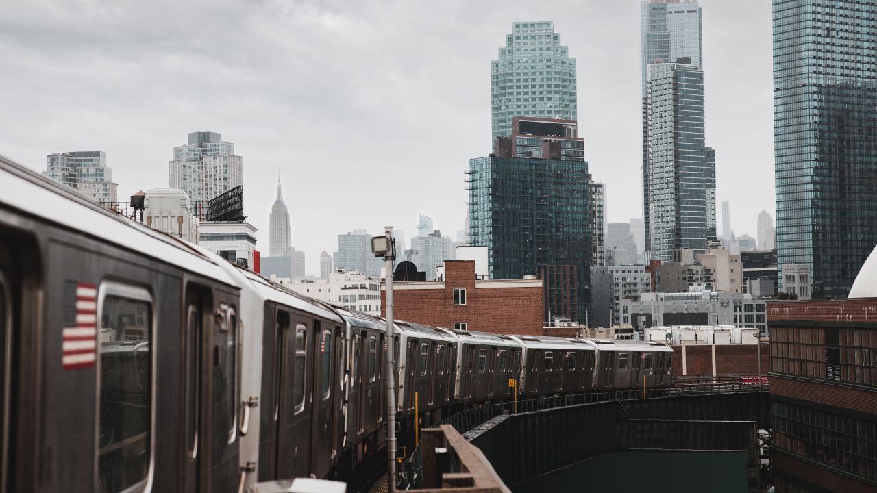 NYC Subway train in Long Island City, Queens with Midtown Manhattan in the background