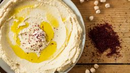 Middle Eastern cuisine: freshly made hummous, a spread made from chickpeas and seasoned with sumac and oil. Served with flat bread.