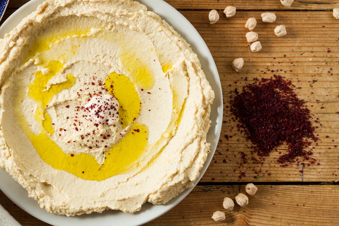 Serve up hummus in a spread made from chickpeas and seasoned with sumac and oil. Sumac can bring out the natural flavors of food much like salt does.