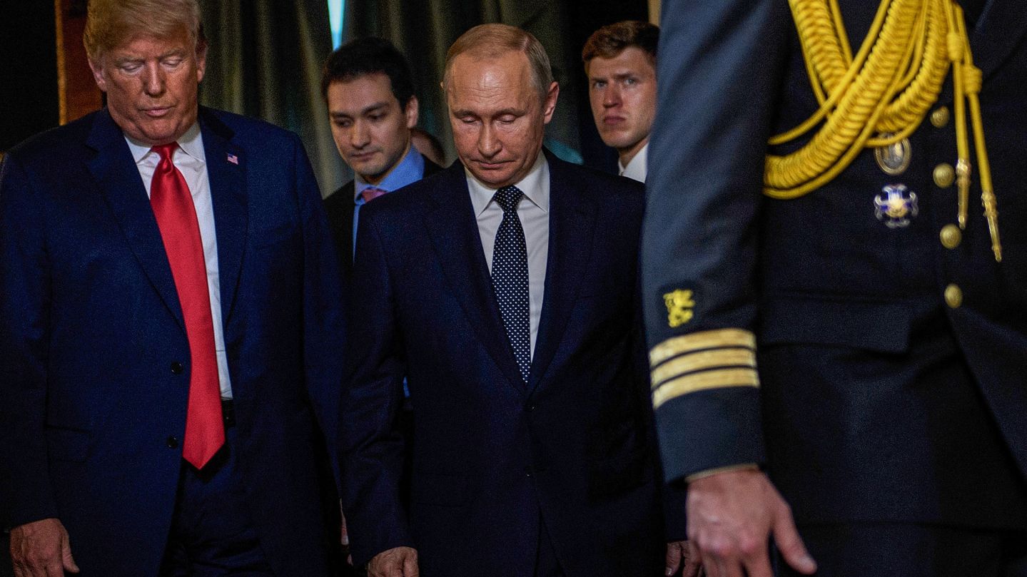 TOPSHOT - US President Donald Trump (L) and Russia's President Vladimir Putin (C) arrive for a meeting at Finland's Presidential Palace on July 16, 2018 in Helsinki, Finland. (Photo by Brendan Smialowski / AFP) (Photo by BRENDAN SMIALOWSKI/AFP via Getty Images)          