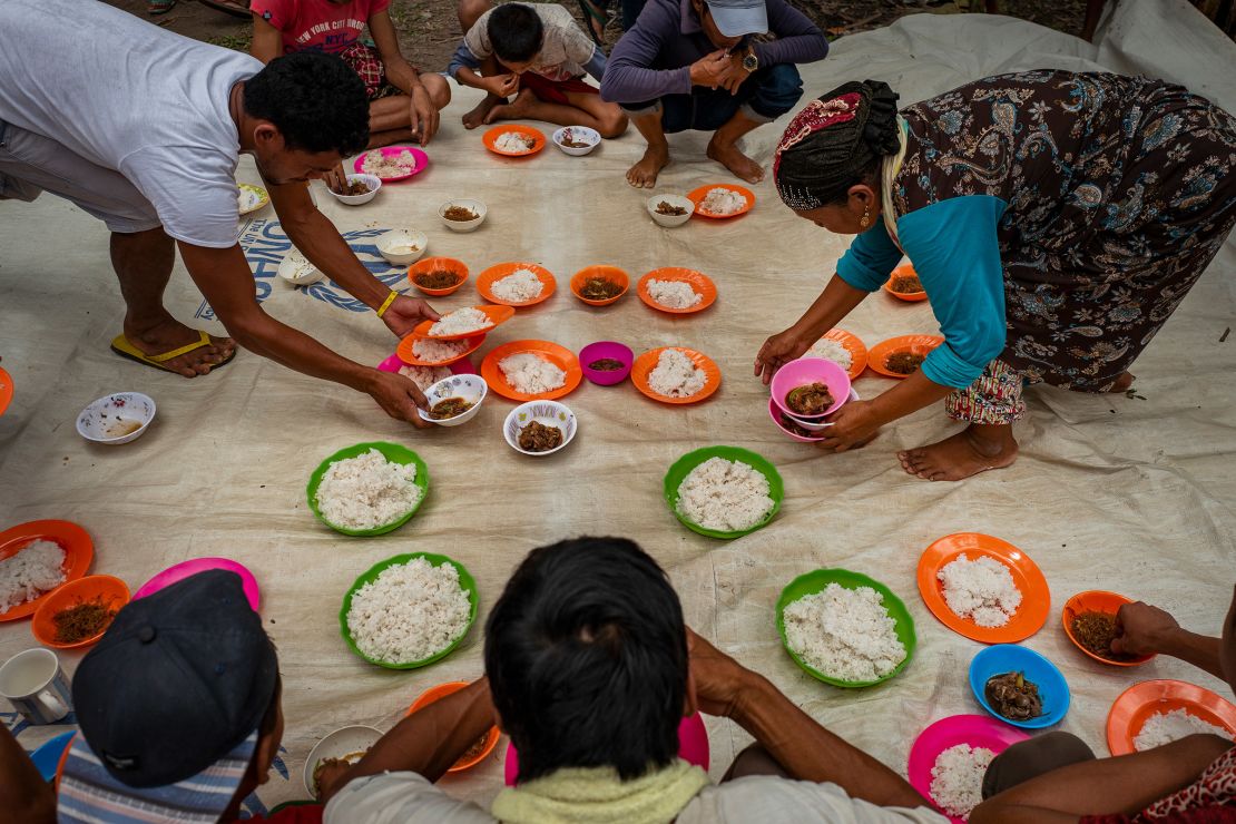 Displaced families prepare food after attending prayer service to celebrate Eid al-Adha in Mamasapano, Central Mindanao, Philippines, on August 21, 2018. Muslims worldwide mark Eid Al-Adha, to commemorate the Prophet Ibrahim's readiness to sacrifice his son as a sign of his obedience to God, during which they sacrifice permissible animals, generally goats, sheep, and cows.