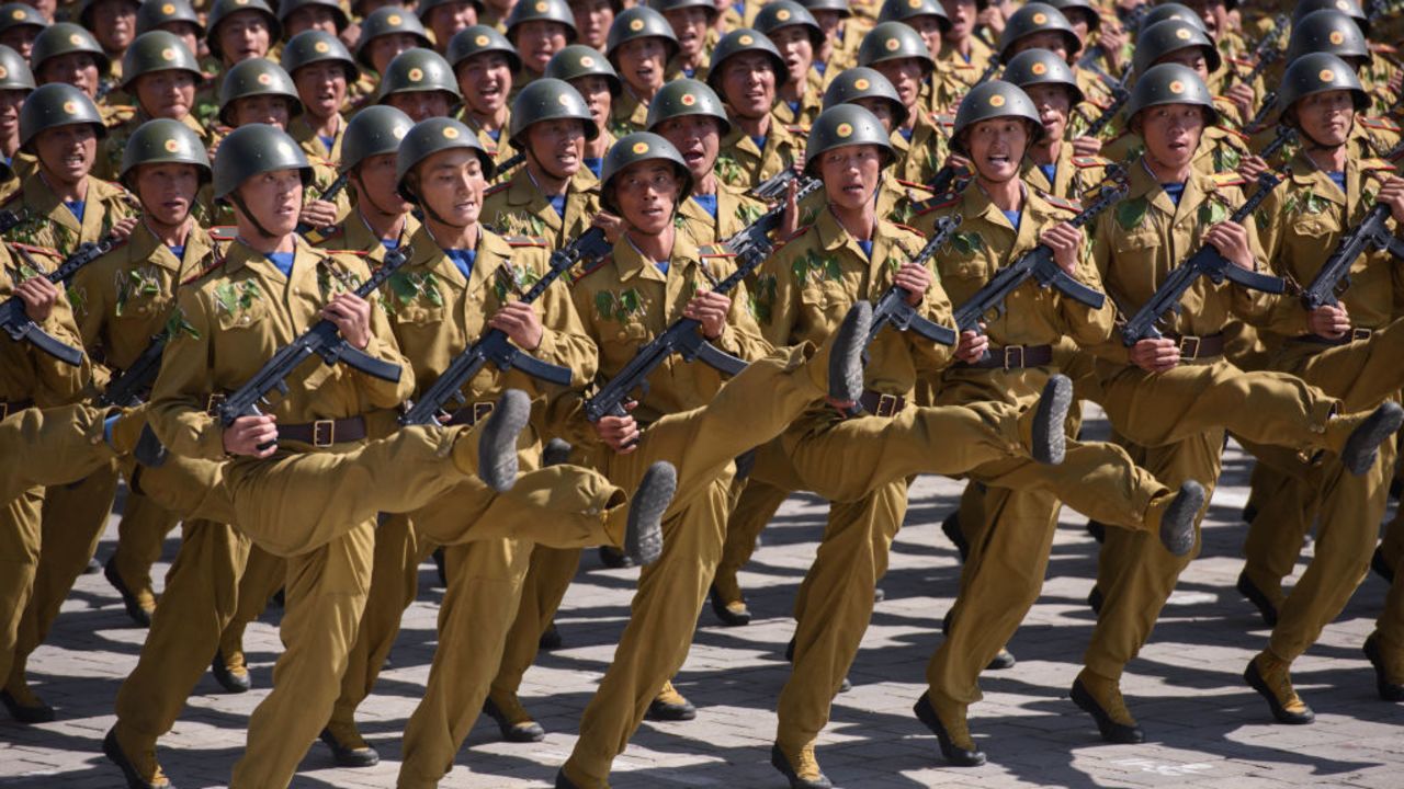 TOPSHOT - Korean People's Army (KPA) soldiers march during a mass rally on Kim Il Sung square in Pyongyang on September 9, 2018. North Korea held a military parade to mark its 70th birthday, but refrained from showing off the intercontinental ballistic missiles that have seen it hit with multiple international sanctions. (Photo by Ed JONES / AFP) (Photo by ED JONES/AFP via Getty Images)