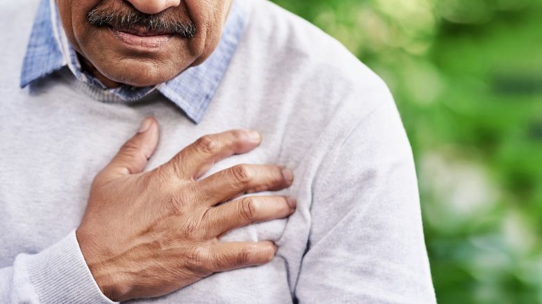 Closeup shot of a man holding his chest