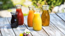 Glass bottles of various fruit juices