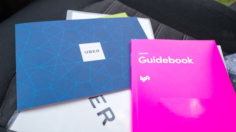 New driver manuals for crowdsourced taxi companies Uber and Lyft, with Uber logo medallion also visible, on seat of a vehicle in San Ramon, California, September 27, 2018. (Photo by Smith Collection/Gado/Getty Images)