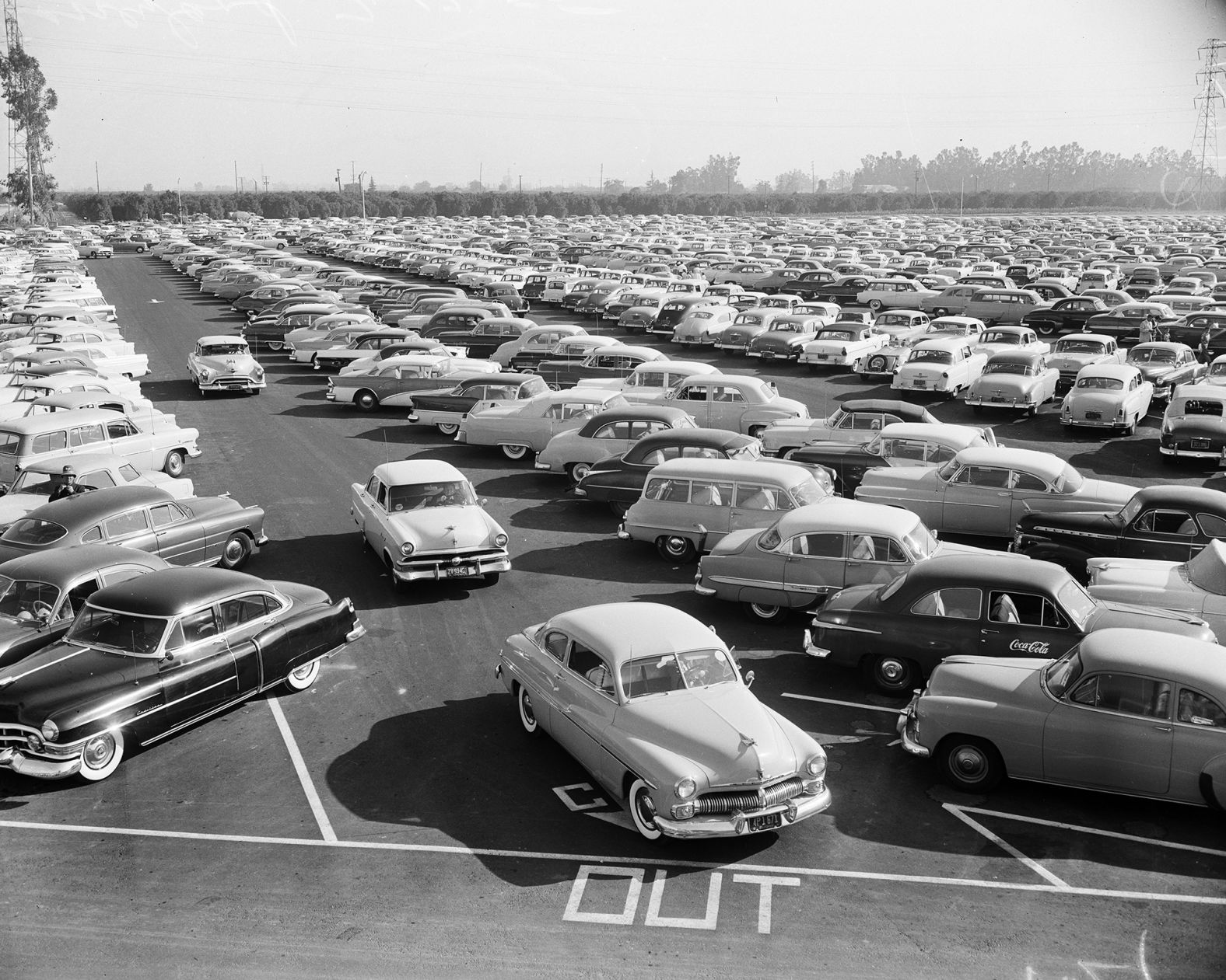 Disneyland's parking lot is full of cars on opening day.