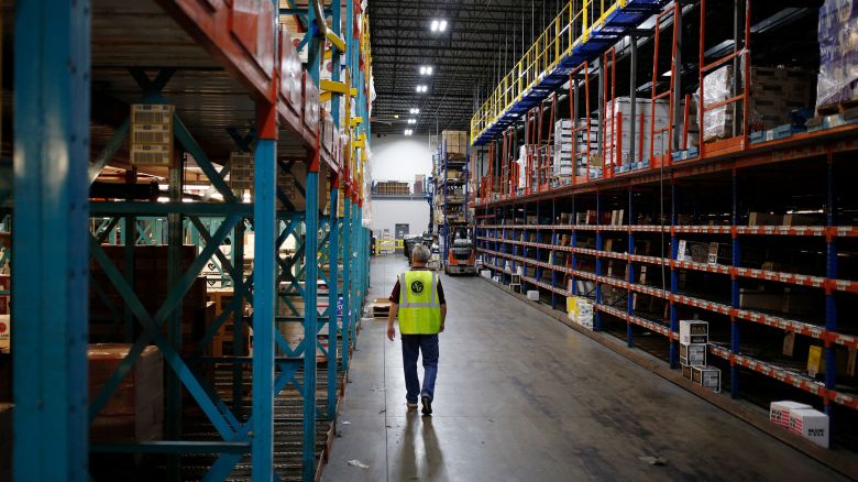 A worker walks down an aisle in the warehouse at Southern Glazer's Wine and Spirits LLC distribution center in Louisville, Kentucky, U.S., on Friday, Sept. 28, 2018.