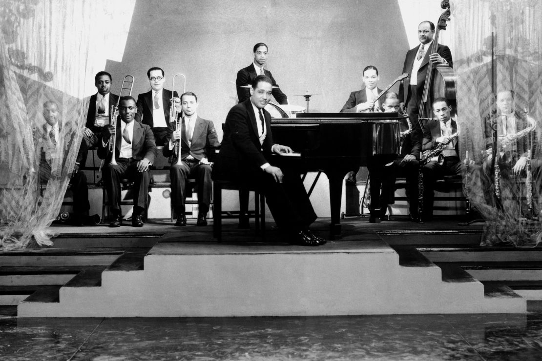 From the 1920s to the 1930s, New York’s Harlem neighborhood became an influential and fertile landscape for Black cultural expression. Pictured is the Duke Ellington Orchestra, named after the American jazz pianist and composer, who sits in the center among his fellow musicians.