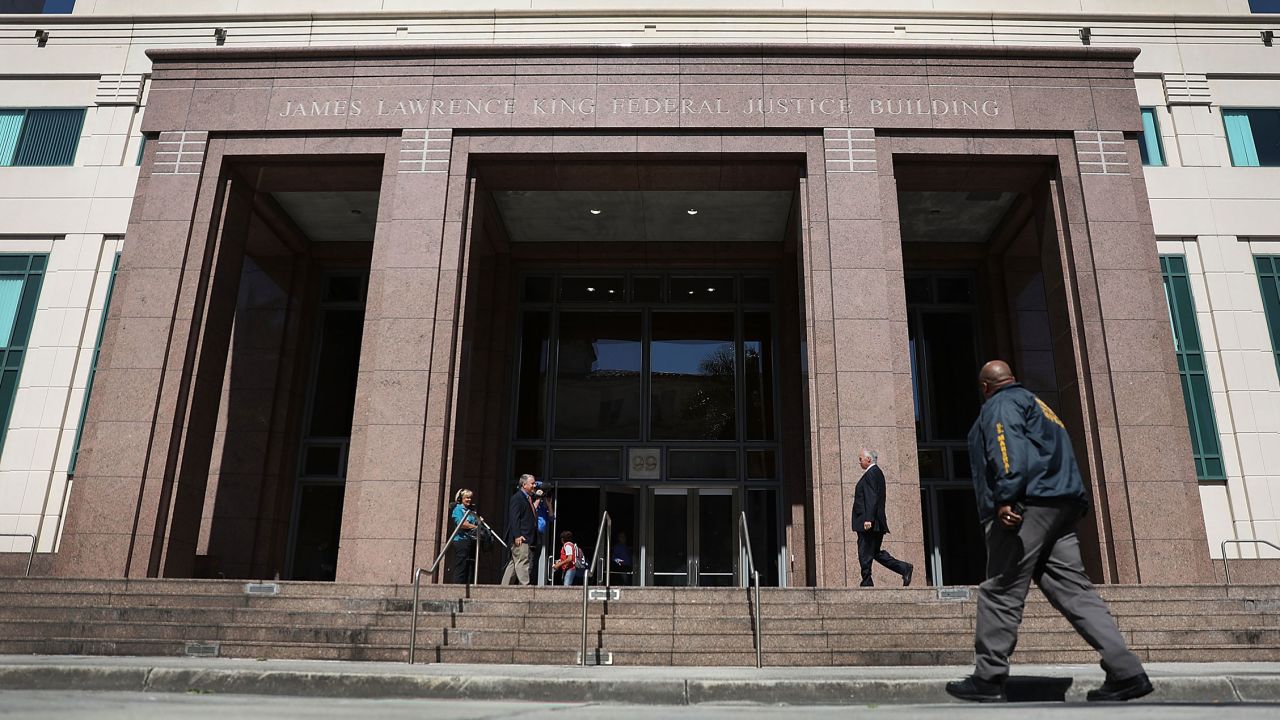 A member of the US Marshals Service walks in front of the federal district court in Miami, Florida in 2018.