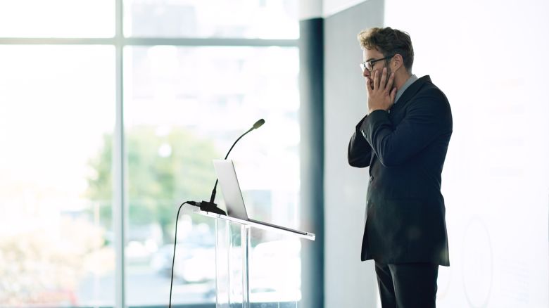 Shot of a young businessman looking nervous while rehearsing a speech at a conference
