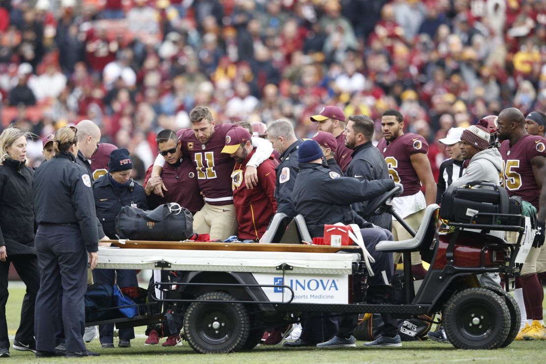 Smith (No. 11) being helped off the field after suffering his injury in 2018.