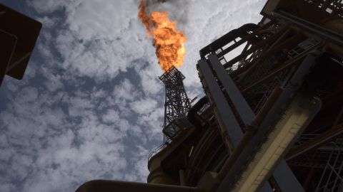 A view of the flare of the Kaombo Norte, an oil tanker converted into a FPSO vessel (Floating Production Storage and Offloading), owned by the French Total oil company, on November 8, 2018, about 250km off the coast of Angola in the Atlantic Ocean. Moored in the endless South Atlantic Ocean far off the coast of Angola, the "Kaombo Norte" oil-extraction vessel is a deeply impressive sight -- 330 metres long, with a tower 110 metres high sending a burning flame into the sky. But inside, daily life on the ship is a different matter, with a crew of about 100 sharing narrow ages and confined spaces, living for weeks at a stretch in close quarters 24 hours a day. (Photo by Rodger BOSCH / AFP) (Photo by RODGER BOSCH/AFP via Getty Images)