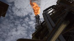 A view of the flare of the Kaombo Norte, an oil tanker converted into a FPSO vessel (Floating Production Storage and Offloading), owned by the French Total oil company, on November 8, 2018, about 250km off the coast of Angola in the Atlantic Ocean. Moored in the endless South Atlantic Ocean far off the coast of Angola, the "Kaombo Norte" oil-extraction vessel is a deeply impressive sight -- 330 metres long, with a tower 110 metres high sending a burning flame into the sky. But inside, daily life on the ship is a different matter, with a crew of about 100 sharing narrow passages and confined spaces, living for weeks at a stretch in close quarters 24 hours a day. (Photo by Rodger BOSCH / AFP) (Photo by RODGER BOSCH/AFP via Getty Images)