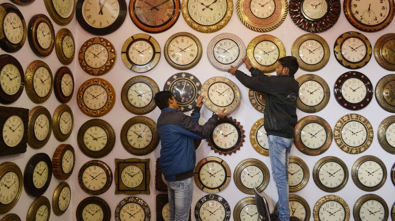 Indian exhibitors hang wall clocks for sale during the 'Punjab International Trade Expo (PITEX) in Amritsar on December 6, 2018. - Exhibitors from Turkey, Egypt, Thailand, Afghanistan and other Asian countries are displaying their products during the fair which runs from December 6-10. (Photo by NARINDER NANU / AFP)        (Photo credit should read NARINDER NANU/AFP via Getty Images)