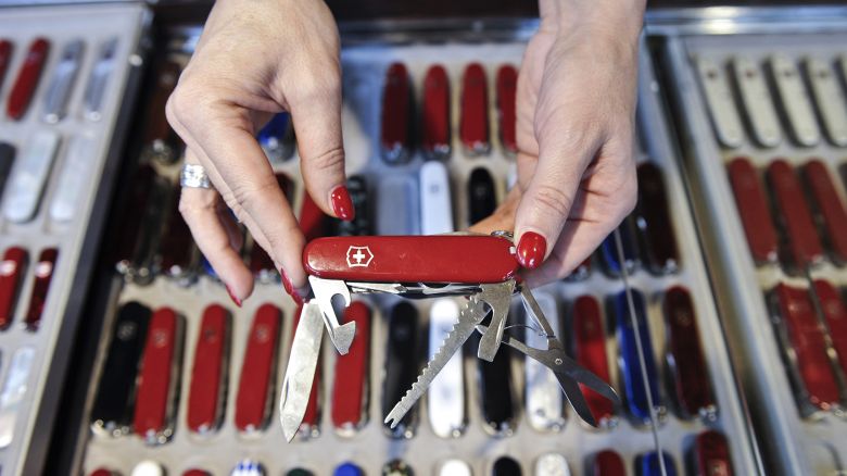 An employee displays a Swiss army penknife for sale at the Victorinox AG factory store in Ibach, Switzerland, on Thursday, Jan. 20, 2011. Victorinox, founded in 1884 in the central Swiss town of Ibach, is the sole provider of the knives after buying rival Wenger SA in 2005. Photographer: Adrian Moser/Bloomberg via Getty Images